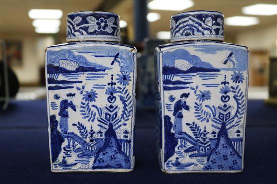 A pair of Dutch delft blue and white lidded tea caddies